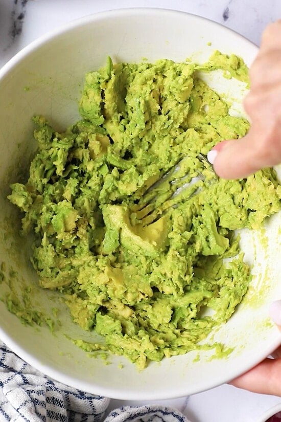 avocados mashed with a fork