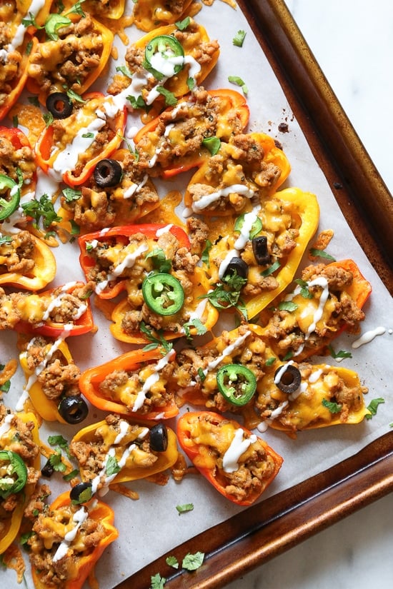 Loaded mini bell pepper nachos – game changer!! These low-carb nachos are loaded with turkey taco meat, cheese and all your favorite nacho toppings!