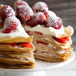 Crepes aren't just for rolling, something special happens with you layer then with cream and top them with strawberries. It creates a beautiful cake-like dessert, when you slice into it, you can see all the layers.