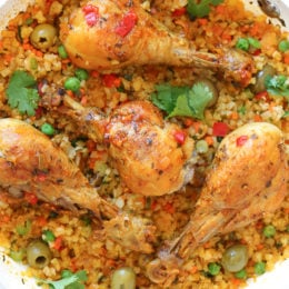Skillet Cauliflower "Arroz" Con Pollo (Spanish chicken and rice) uses cauliflower rice as a low-carb swap, which means larger portions with 85% less calories than rice!