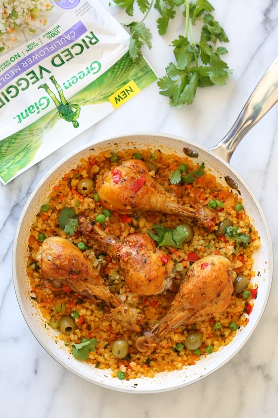 Skillet Cauliflower "Arroz" Con Pollo (Spanish chicken and rice) is a dish I grew up eating, and is pure comfort food to me. This low-carb version swaps the rice for veggies, which means larger portions with 85% less calories than rice!