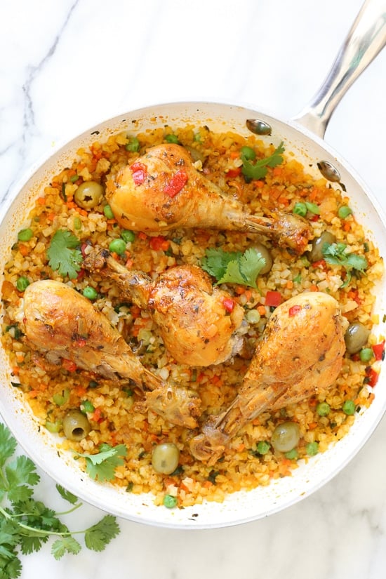 Spanish chicken and rice, a dish I grew up eating, is pure comfort food to me. This low-carb version swaps the rice for veggies, which means larger portions with 85% less calories than rice!