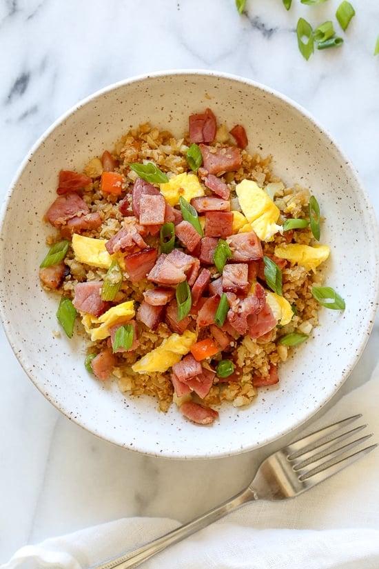 Cauliflower Fried "Rice" with Leftover Ham is a great way to use up that leftover ham from the Holidays, without the calories and carbs you may have over-indulged on.