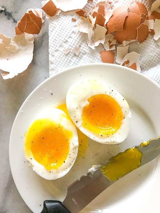 A soft boiled egg cut in half on a plate
