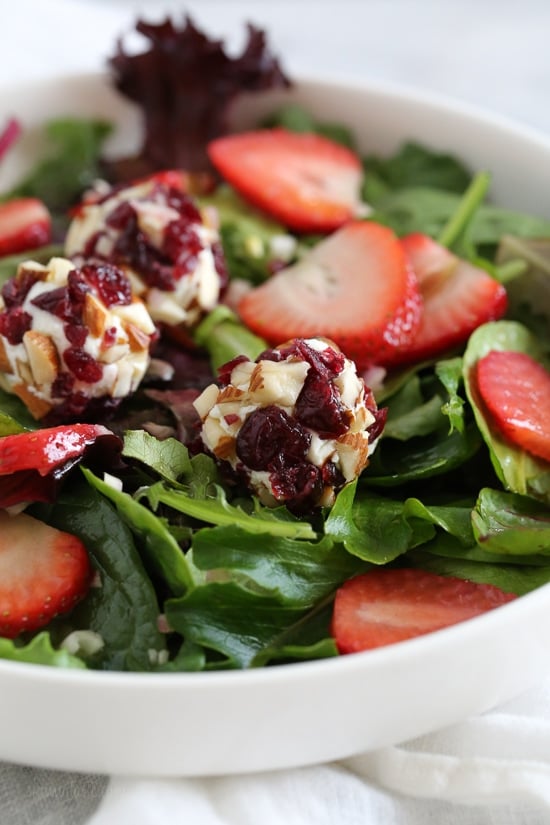 This beautiful Spring Berry Salad with Almond-Cranberry Crusted Goat Cheese is studded with strawberries and served over baby greens, but you can use any seasonal berries or a combination of berries instead. Serve this salad alone or alongside grilled chicken or fish. 