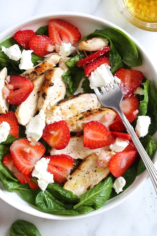 Grilled Chicken Salad with Strawberries and Spinach is all I've been craving now that Spring is in full bloom! I made this with creamy goat cheese and a white balsamic dressing, but this would also be great with Feta cheese and if you want to add more protein, or skip the cheese add walnuts or slivered almonds.