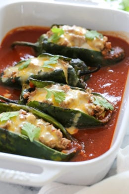 These baked Turkey Enchilada Stuffed Poblanos Rellenos are peppers stuffed with a flavorful ground turkey filling, topped with my homemade enchilada sauce and cheese. 