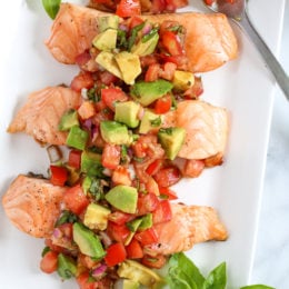 Grilled salmon is so easy to make with this foolproof method, you'll be grilling it outdoors all summer long! Topped with this fresh avocado bruschetta, this dish just screams summer!