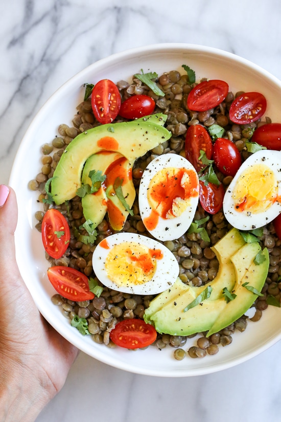 Lentils with hard boiled eggs, tomatoes, avocado, a squeeze of lime juice, cilantro and a few dashes of hot sauce is a really simple meatless lunch I like to make for myself anytime I have cooked lentils (or sometimes I buy them cooked).