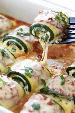 Zucchini Rollatini is low-carb and delicious! Made with strips of grilled zucchini stuffed with a basil-cheese filling, then rolled and topped with marinara, mozzarella and baked in the oven until the cheese is hot and melted.