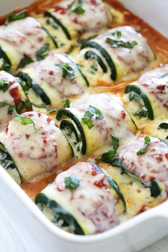 Zucchini Rollatini is low-carb and delicious! Made with strips of grilled zucchini stuffed with a basil-cheese filling, then rolled and topped with marinara, mozzarella and baked in the oven until the cheese is hot and melted.