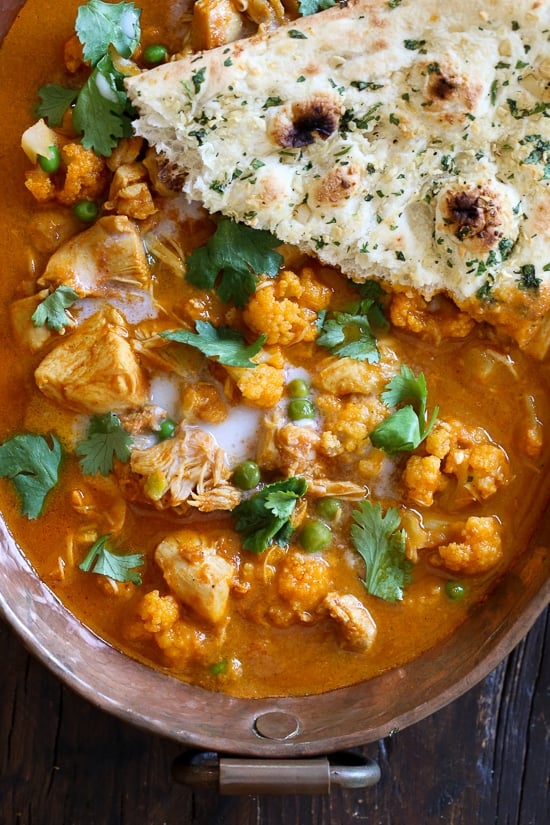 I've created a lightened up, dairy-free Chicken Tikka Masala with Cauliflower and Peas in the Instant Pot to satisfy my craving for Indian food! This mild curry is made with boneless chicken thighs cooked in a tomato base, with lots of spices and coconut milk. You can serve this with garlic naan or basmati rice on the side (cauliflower rice would work too to keep it low carb!)