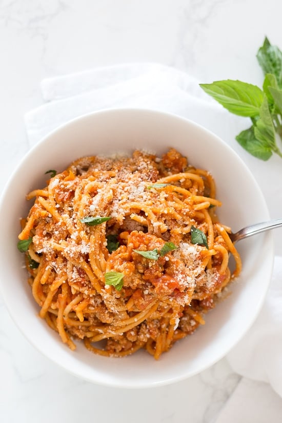 Instant Pot One-Pot Spaghetti with Meat Sauce is made with ground turkey and whole wheat pasta – hands down, the quickest and easiest way to get dinner on the table while making the whole family happy! Your solution to getting dinner on the table FAST on those busy weeknights and having everyone clean their plates!