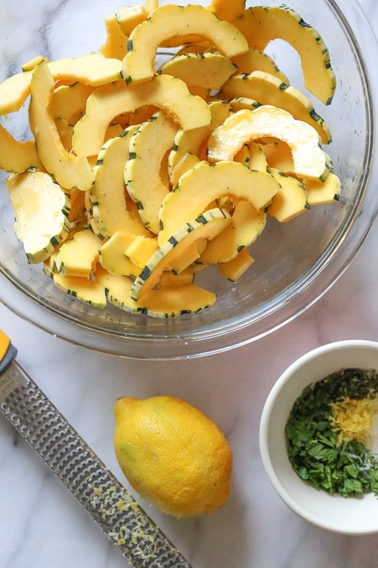Roasted Delicata squash sliced into half moons before roasting.
