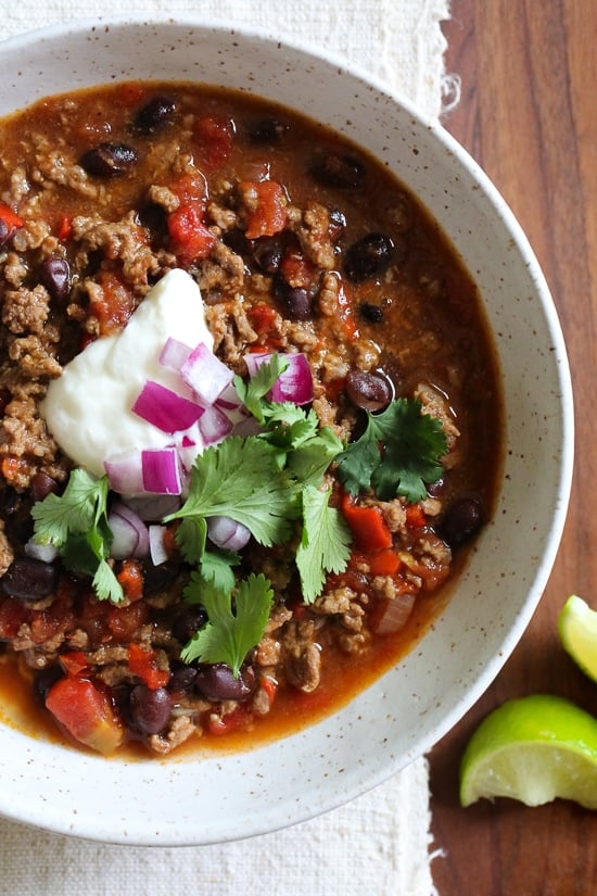 I love this quick and easy beef chili made with black beans, tomatoes, homemade chili spices and beer. This chili pleases all the palates in my house – not to too spicy (although you can kick it up if you wish), loaded with flavor, and ready in less than 30 minutes. #chili #instantpot #recipe #glutenfree #beef 