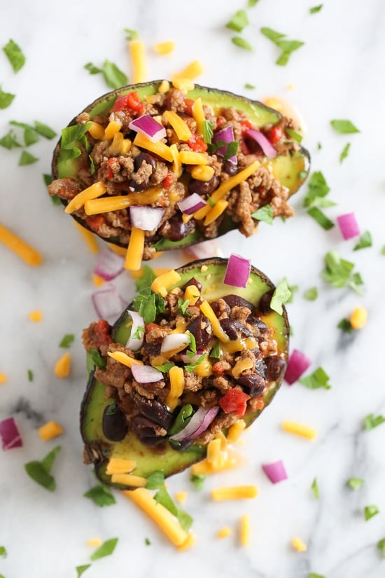 Avocados stuffed with beef chili and topped with shredded cheese