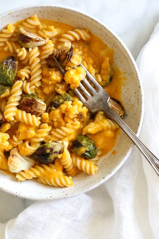 It's October, so Pumpkin Mac and Cheese with Roasted Cauliflower and Brussels Sprouts is a must for the Fall! Using pumpkin puree makes a creamy light cheese sauce, without having to add cream or too much cheese. You can make your own pumpkin puree or use organic canned pumpkin to make it faster!