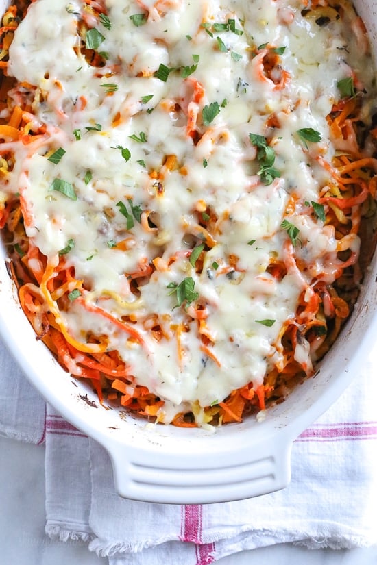 Spiralized Winter Veggie Gratin is the perfect holiday side dish! Made with spiralized vegetable gratin is made with sweet potatoes, butternut squash, carrots, and parsnips and topped with a white sauce and Gruyere cheese.