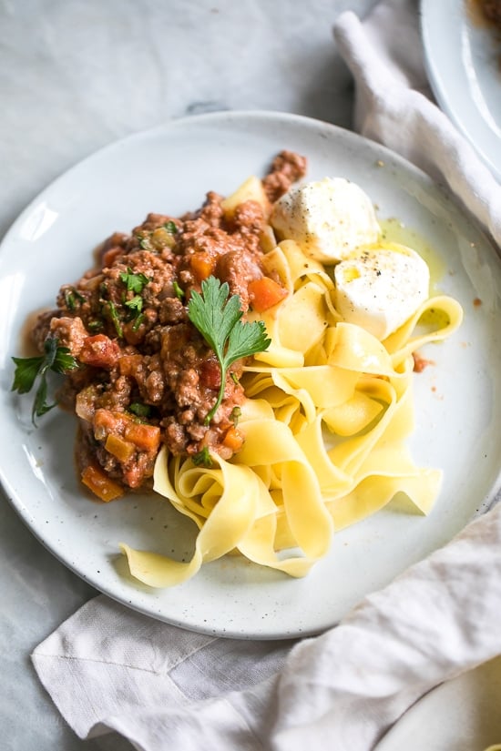 This is the best, easy Bolognese sauce recipe, a staple in my home. I always make a big batch for dinner and freeze the rest to use throughout the month – a huge time saver! Making it in the pressure cooker makes this Sunday sauce a dish you can whip up any night of the week!