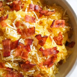 Roasted spaghetti squash with bacon and Parmesan cheese is a great way to top spaghetti squash for an easy, tasty side dish. Although there are several methods to cook spaghetti squash, my favorite way to make it is roasted. To roast the squash, I cut it on half lengthwise, remove the seeds and cook it cut down for about one hour.