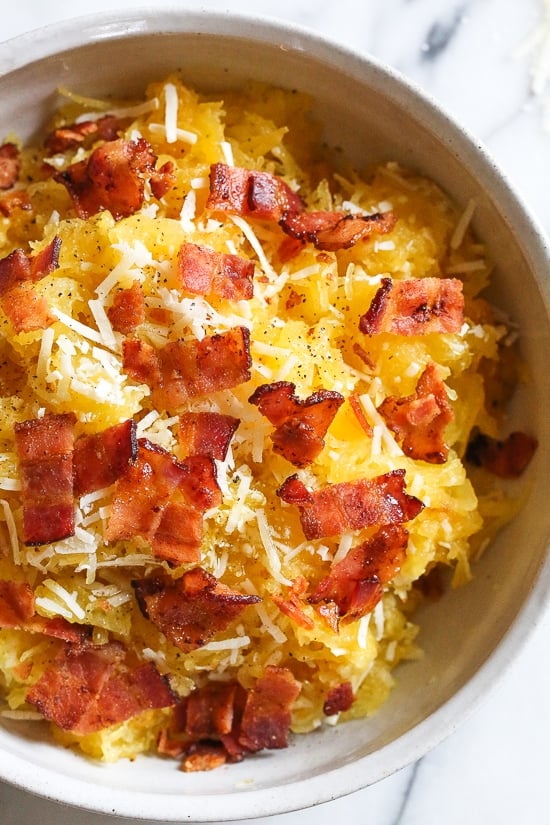 Roasted spaghetti squash with bacon and Parmesan cheese is a great way to top spaghetti squash for an easy, tasty, low-carb side dish. Although there are several methods to cook spaghetti squash, my favorite way to make it is roasted. To roast the squash, I cut it on half lengthwise, remove the seeds and cook it cut down for about one hour.