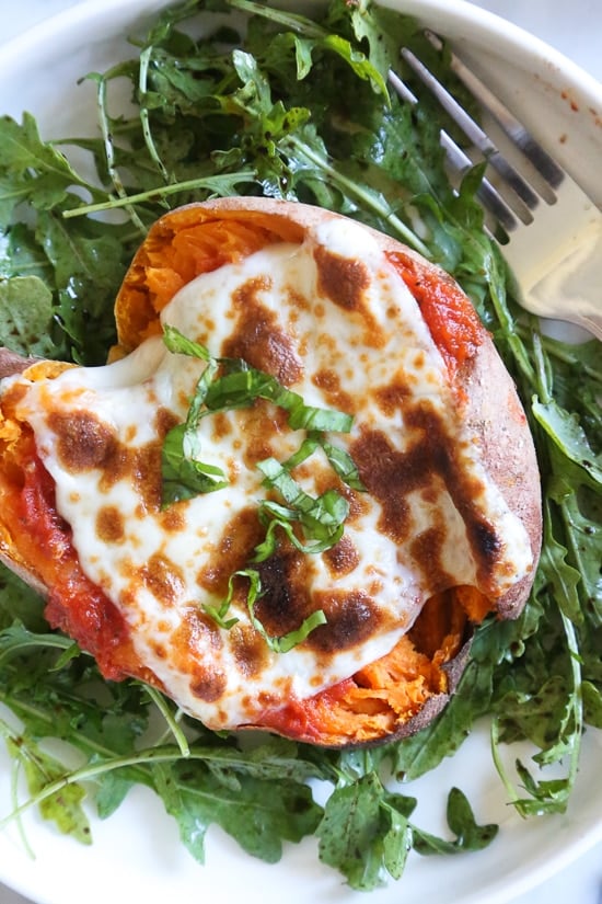 These savory stuffed sweet potatoes are topped with Italian flavors such as marinara sauce and mozzarella cheese. A quick and easy healthy vegetarian dish.