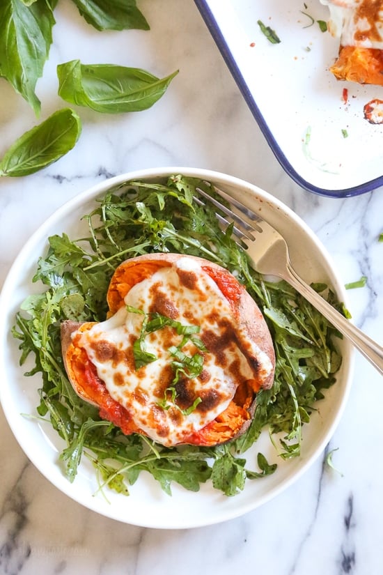 These savory stuffed sweet potatoes are topped with Italian flavors such as marinara sauce and mozzarella cheese. A quick and easy healthy vegetarian dish.