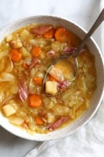 If you're making a big bone-in ham for the holidays this year, don’t throw away the leftover ham bone once all the meat’s been cut off. It’s a key ingredient in this soup that adds instant flavor with minimal effort! Here I added some vegetables, potatoes and cabbage, there are no beans but you can add some if you wish. So delicious and easy to make!