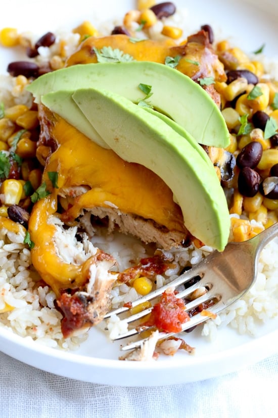 This EASY Slow Cooker Chicken dish is cheesy and delicious, made with boneless chicken breast, black beans, corn and salsa topped with melted cheddar cheese. YUM!
