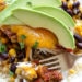 This EASY Slow Cooker Chicken dish is cheesy and delicious, made with boneless chicken breast, black beans, corn and salsa topped with melted cheddar cheese. YUM!