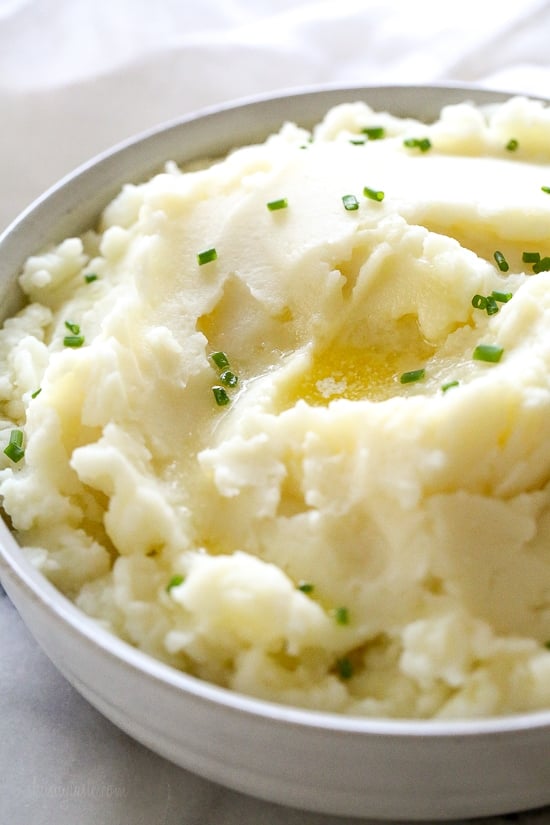 A bowl of creamy Instant Pot mashed potatoes topped with chopped chives.