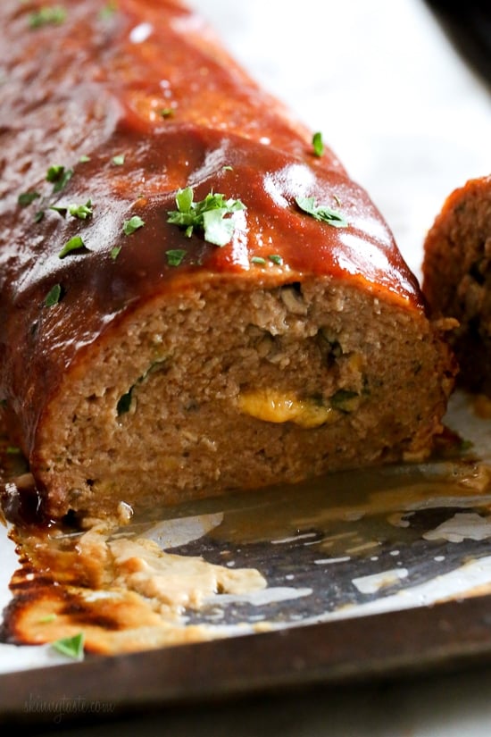 The best tasting, moist turkey meatloaf stuffed with cheddar cheese, spinach and rolled, jelly roll style topped with a ketchup based glaze. 