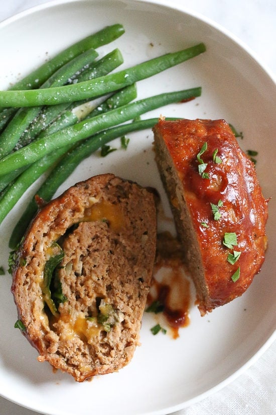 Best tasting moist turkey meatloaf stuffed jelly roll style topped with cheddar cheese, spinach and ketchup based glaze.