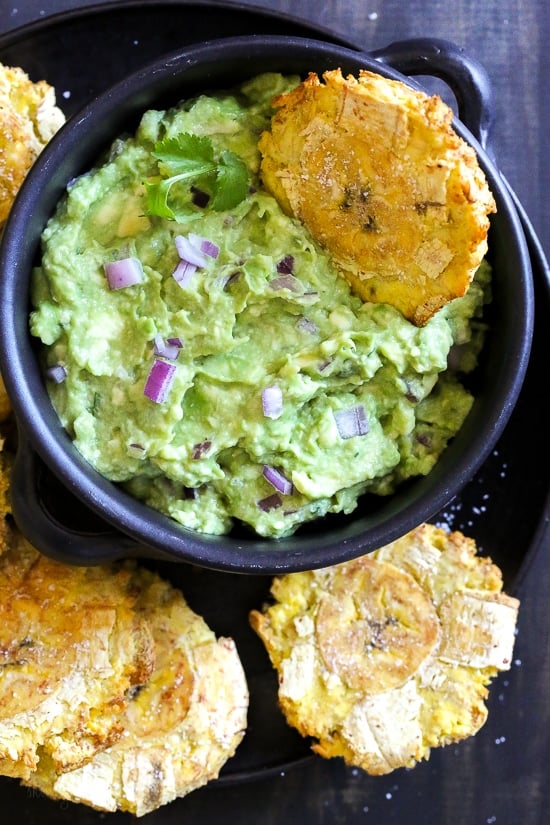 These easy tostones also known as patacones or fried green plantains are made healthier in the air fryer. No deep frying, just a few spritzes of olive oil for a crispy, delicious appetizer or side dish.