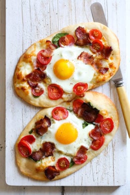 This homemade breakfast pizza is made with bacon, eggs, tomatoes, spinach and cheese, made completely from scratch and ready in less than 30 minutes start to finish!