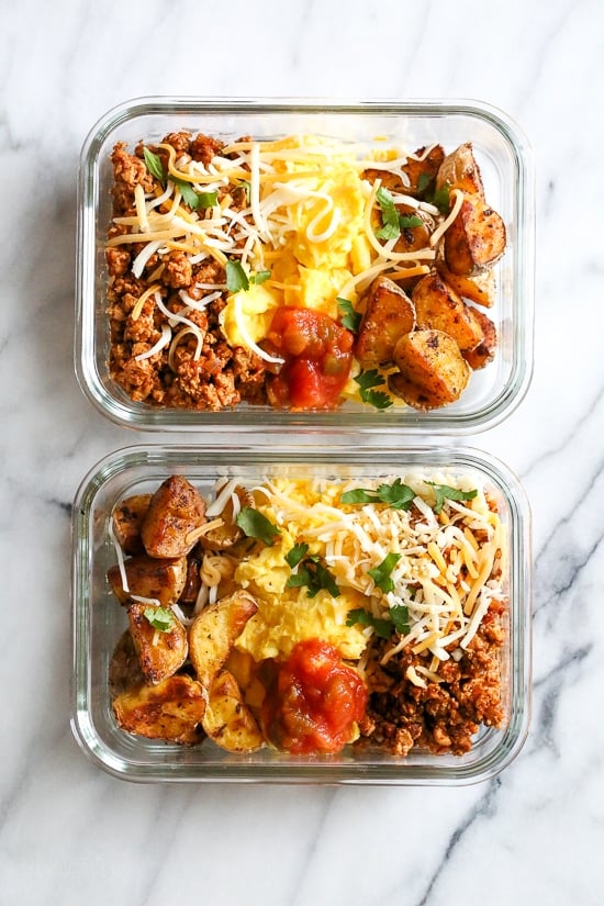 Breakfast lovers, jazz up your mornings with this Meal Prep Breakfast Taco Scramble, made with potatoes, turkey taco meat, scrambled eggs and salsa (cheese is optional!) perfect to make ahead for breakfast for the week!
