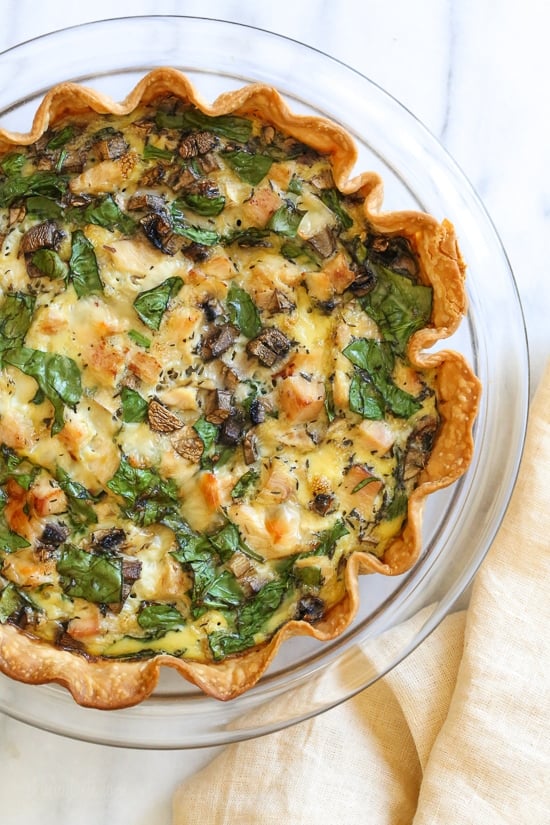This easy lighter chicken quiche is made with refrigerated pie crust and loaded with spinach and mushrooms but you can use any combination of vegetables. A great recipe to clean out the refrigerator! 