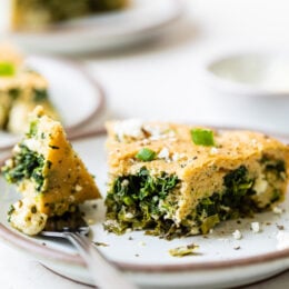 Spinach and Feta Pie cut into a wedge on a plate with a fork.