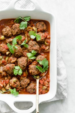Moroccan Kefta Meatballs made with tomatoes and olives are simmered together in the slow cooker or Instant Pot in this easy and exotic Moroccan dinner. Whole30, gluten-free and Paleo.