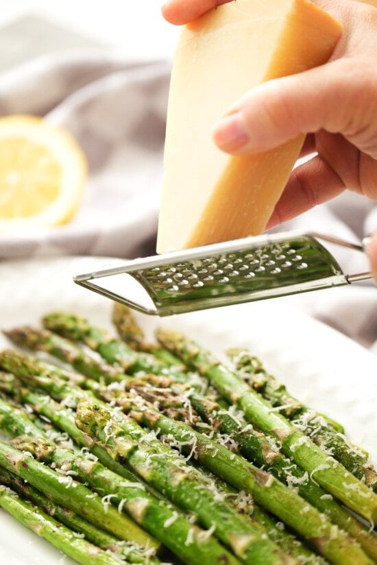 grate parmesan cheese over roasted asparagus