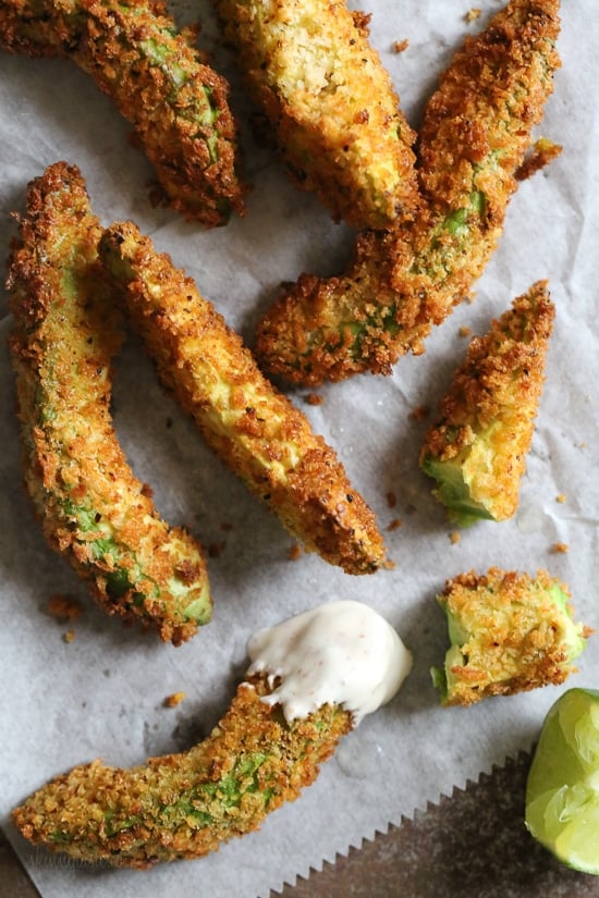 Crispy baked avocado fries coated with panko breadcrumbs with a lime dipping sauce. So fast and easy to make in the oven or air fryer!