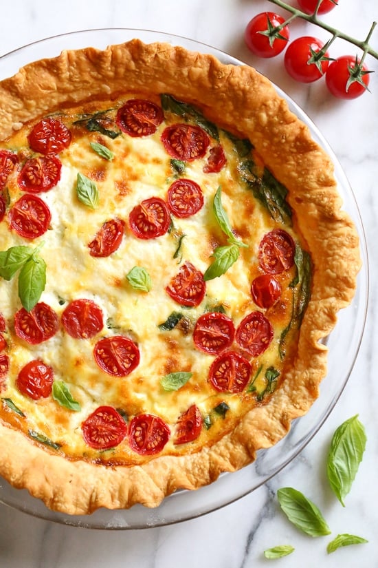This vegetarian quiche recipe is made with spinach, ricotta cheese, eggs, tomatoes and basil. Perfect for breakfast, lunch or brunch or serve it with a salad for a light dinner.