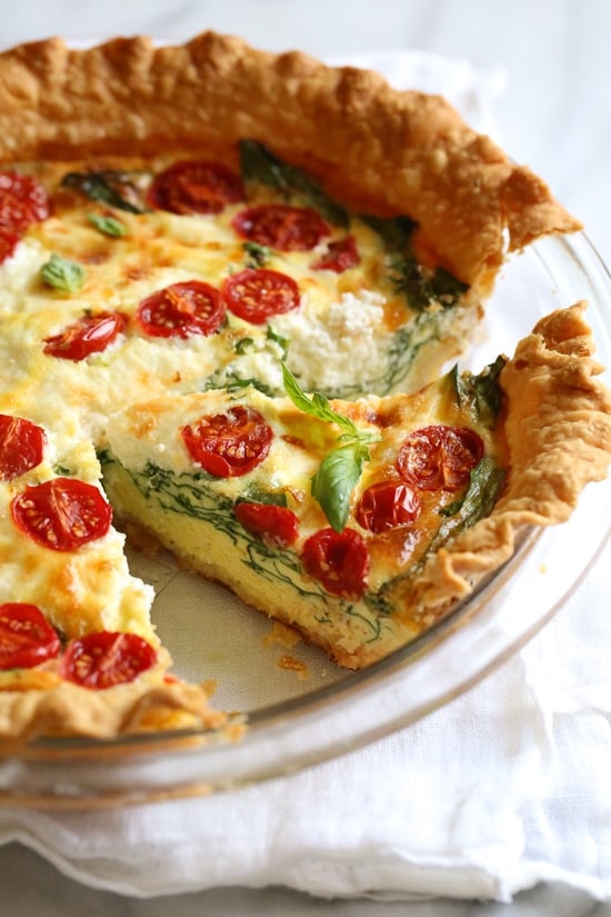 This easy vegetarian quiche recipe is made with spinach, ricotta cheese, eggs, tomatoes and basil. Perfect for breakfast, lunch or brunch or serve it with a salad for a light dinner.
