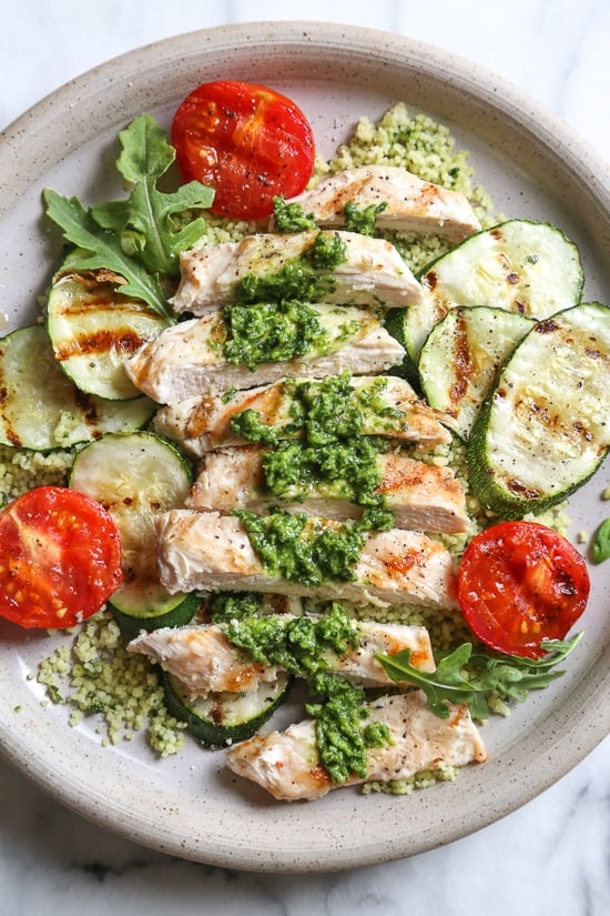 Grilled chicken, zucchini and tomatoes topped with a light spinach-arugula basil pesto served over couscous.