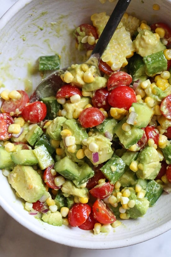 This Corn Tomato Avocado Salad is summer in a bowl! The perfect side dish with anything you're grilling, or double the portion as a main dish.