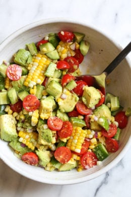 perfect summer corn salad with avocado, cucumbers and tomato