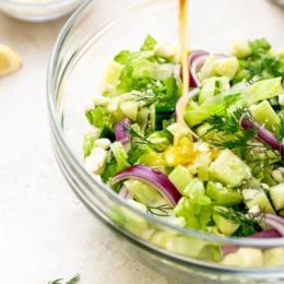 Chopped salad with romaine lettuce, Feta cheese, cucumbers, red onion and dill tossed with a simple red wine vinaigrette. An easy side salad to go with all your Mediterranean dishes.