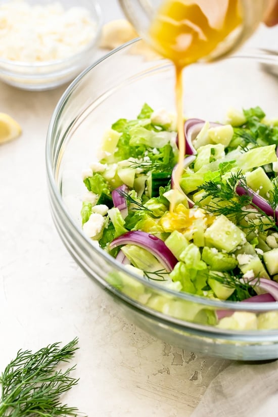 Chopped salad with romaine lettuce, Feta cheese, cucumbers, red onion and dill tossed with a simple red wine vinaigrette. An easy side salad to go with all your Mediterranean dishes.