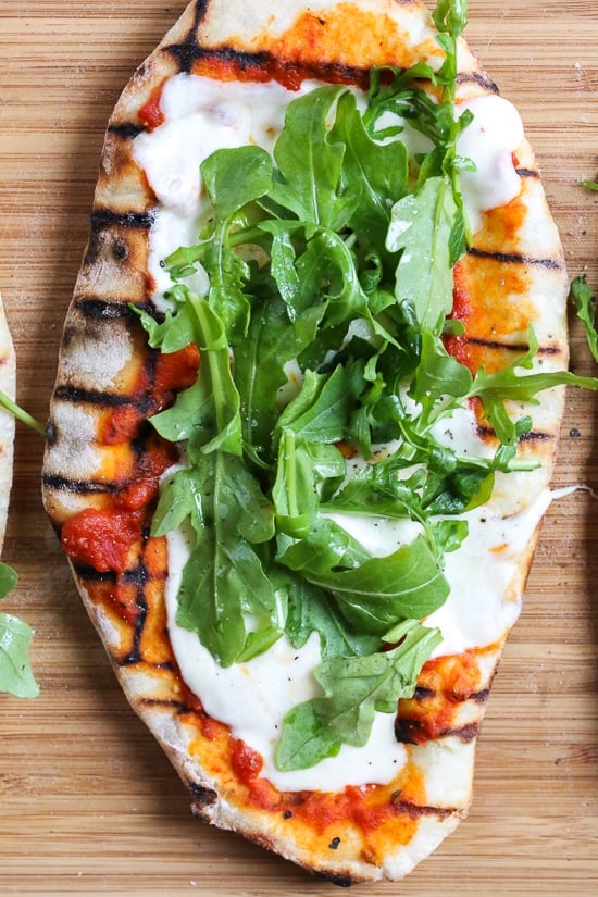 This easy Grilled Pizza is made from scratch with my easy yeast-free Greek yogurt dough, topped with sauce, mozzarella cheese and your choice of toppings. A great summer outdoor meal that whole family can enjoy!