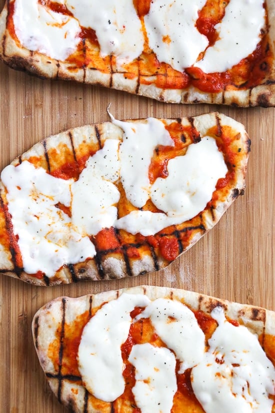 This easy Grilled Pizza is made from scratch with my easy yeast-free Greek yogurt dough, topped with sauce, mozzarella cheese and your choice of toppings. A great summer outdoor meal that whole family can enjoy!